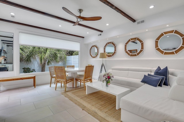 living room featuring light tile patterned flooring, ceiling fan, and beam ceiling