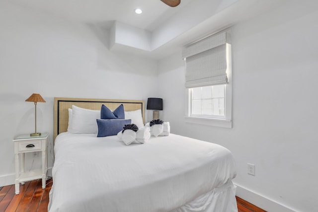 bedroom with dark wood-type flooring and ceiling fan