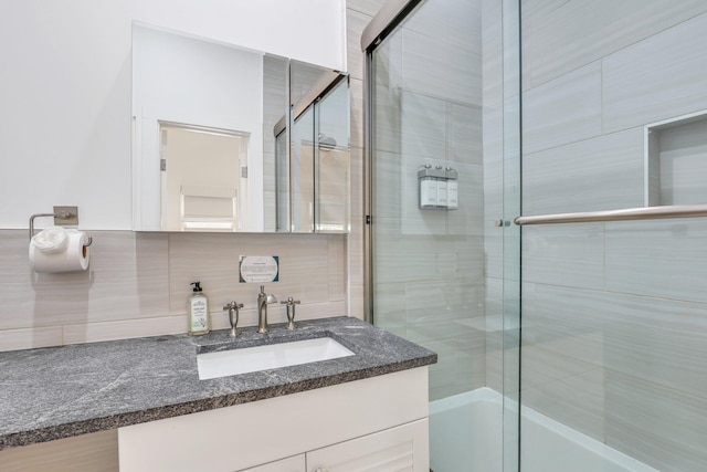 bathroom featuring tasteful backsplash and vanity