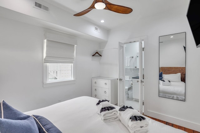 bedroom with hardwood / wood-style flooring, ceiling fan, and connected bathroom