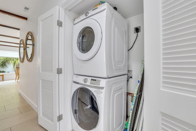 washroom with stacked washer and dryer