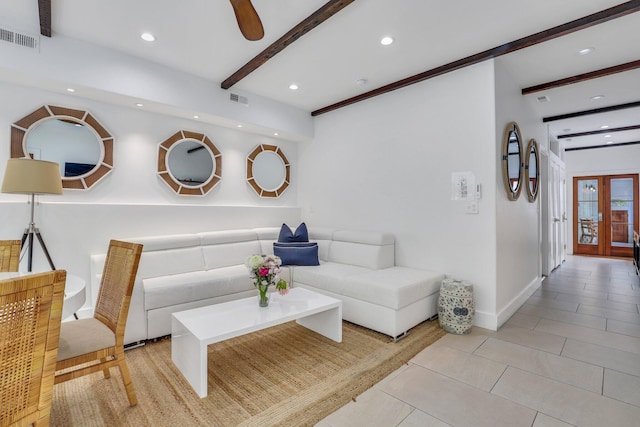 living room with beamed ceiling and light tile patterned floors