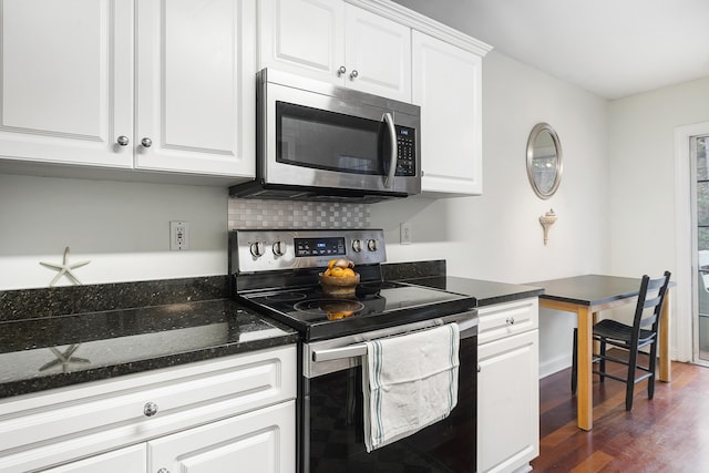 kitchen featuring white cabinets, decorative backsplash, stainless steel appliances, and dark wood-type flooring