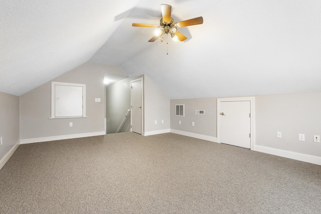 bonus room featuring lofted ceiling, carpet flooring, visible vents, and baseboards