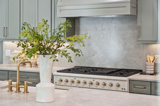 kitchen featuring stove, custom exhaust hood, decorative backsplash, and gas cooktop