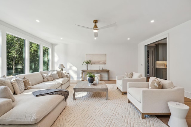 living room with light hardwood / wood-style floors and ceiling fan