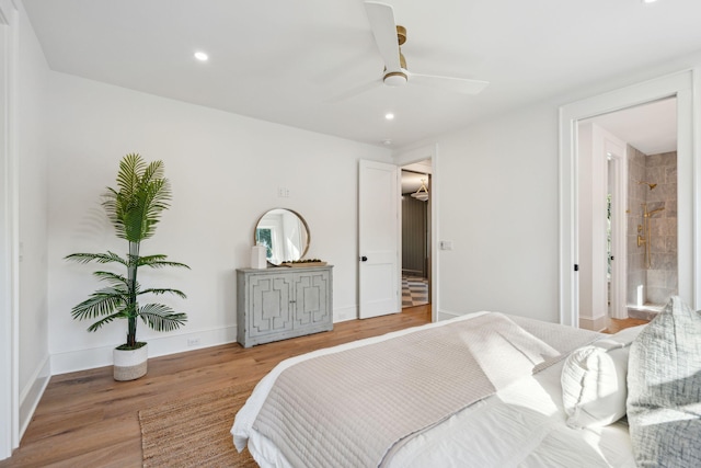 bedroom featuring ceiling fan, connected bathroom, and light hardwood / wood-style flooring