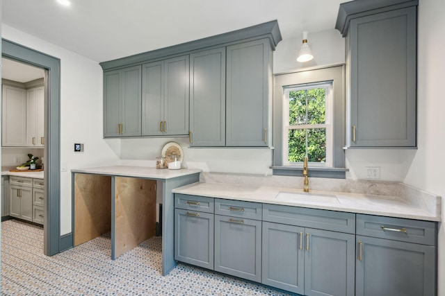 kitchen featuring gray cabinets and sink