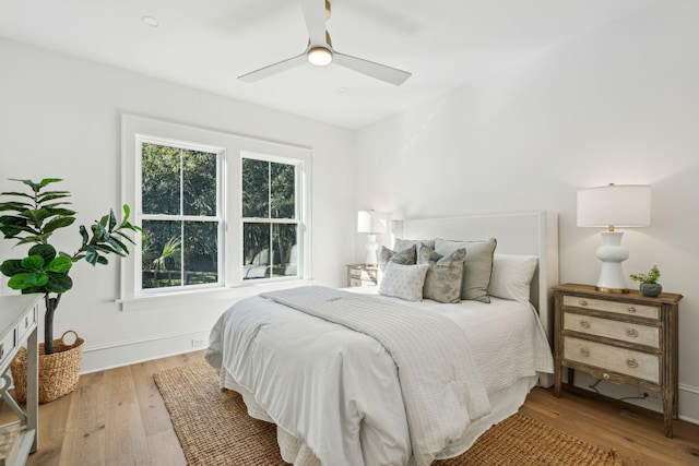 bedroom with ceiling fan and light hardwood / wood-style flooring