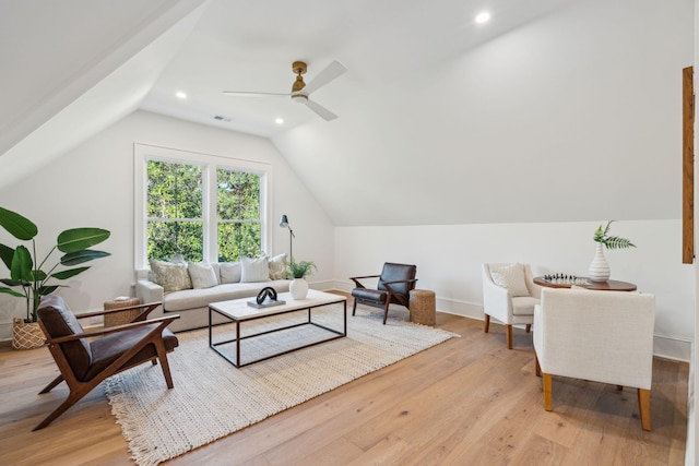 living room with light wood-type flooring, vaulted ceiling, and ceiling fan