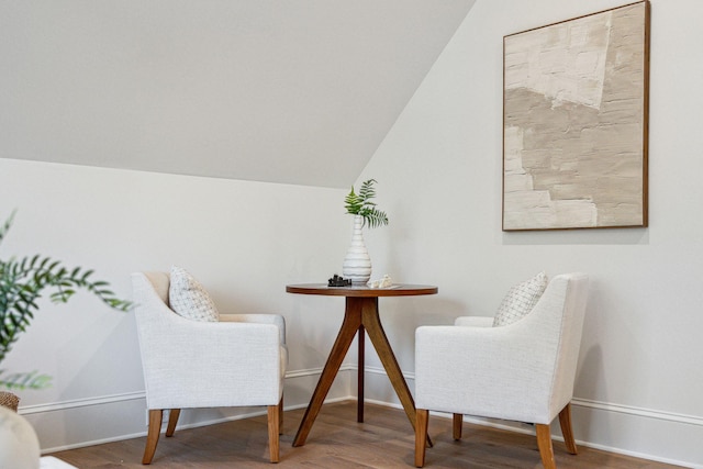 sitting room featuring hardwood / wood-style flooring and lofted ceiling