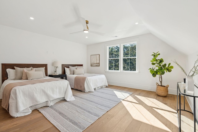 bedroom featuring lofted ceiling, ceiling fan, and light hardwood / wood-style flooring