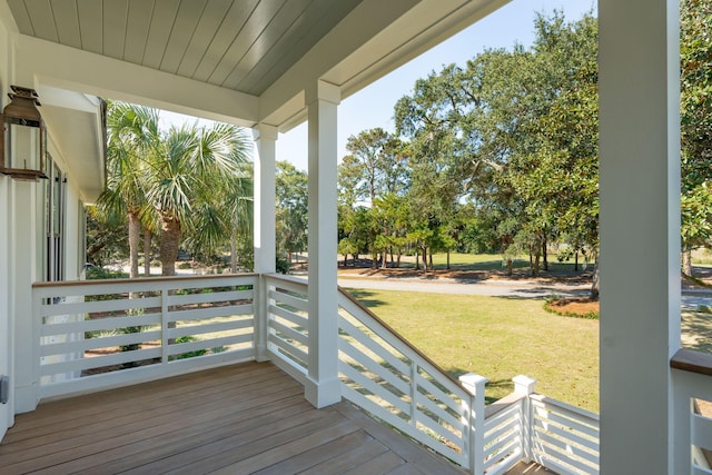 deck with a porch and a yard