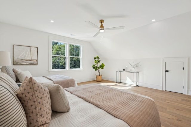 bedroom featuring ceiling fan, lofted ceiling, and light hardwood / wood-style floors