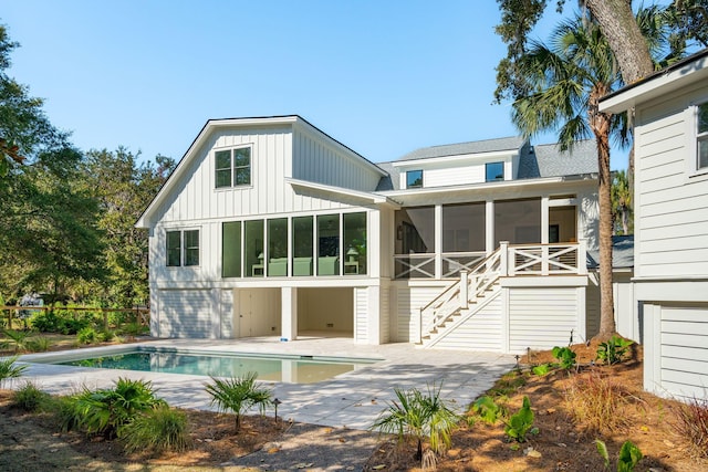 rear view of house featuring a patio and a sunroom