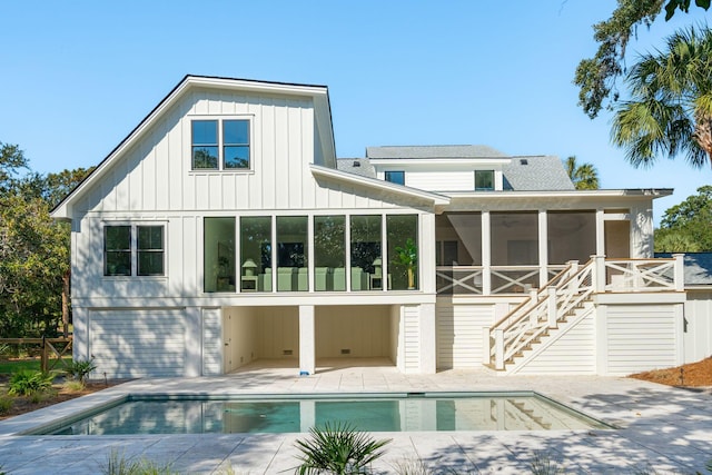 rear view of house with a sunroom and a patio area