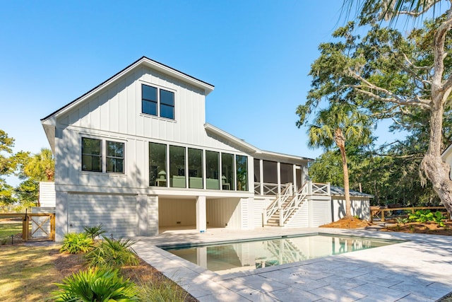 rear view of property with a sunroom and a patio