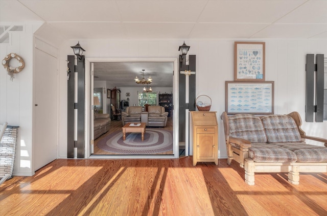 interior space with wood-type flooring and a notable chandelier