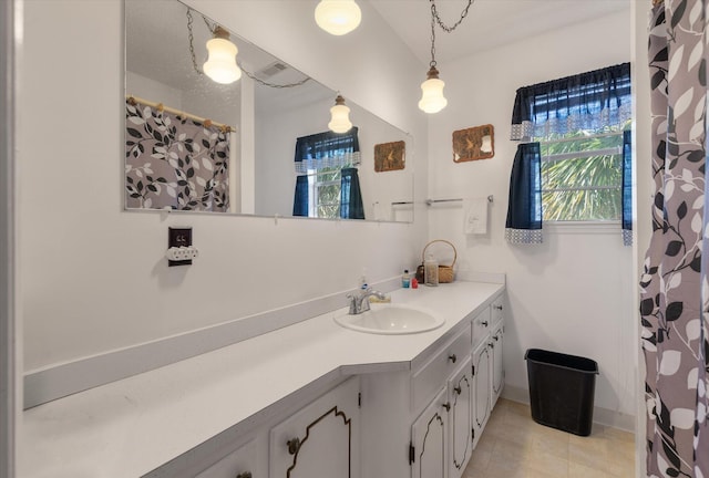 bathroom featuring tile patterned flooring and vanity