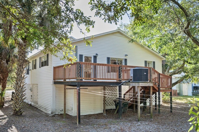 rear view of house with central AC unit and a deck