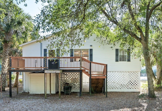 rear view of property featuring a wooden deck