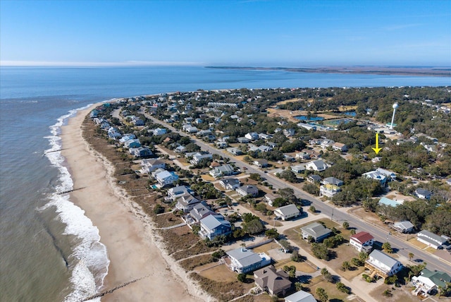 drone / aerial view featuring a beach view and a water view