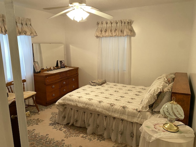 bedroom featuring ceiling fan and light colored carpet