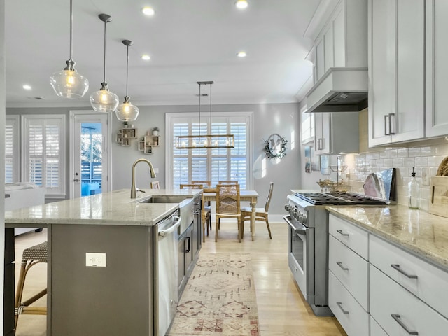 kitchen featuring sink, white cabinetry, a kitchen island with sink, and stainless steel appliances