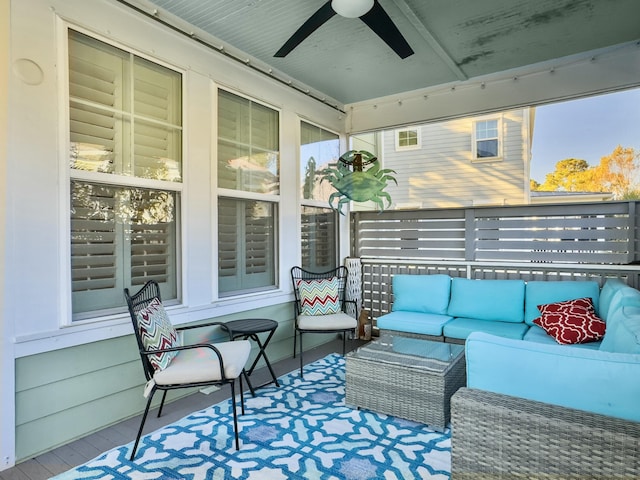 wooden deck featuring outdoor lounge area and ceiling fan