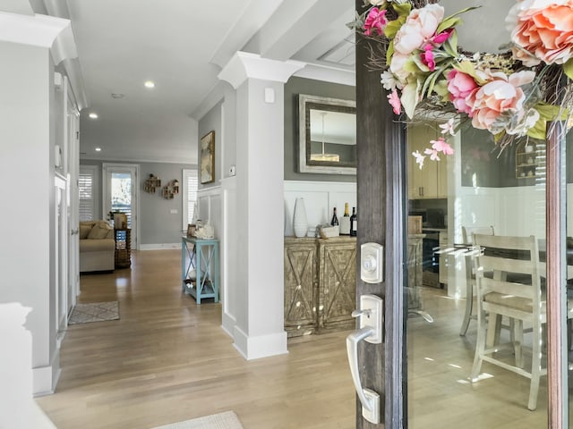 interior space featuring light hardwood / wood-style flooring and crown molding