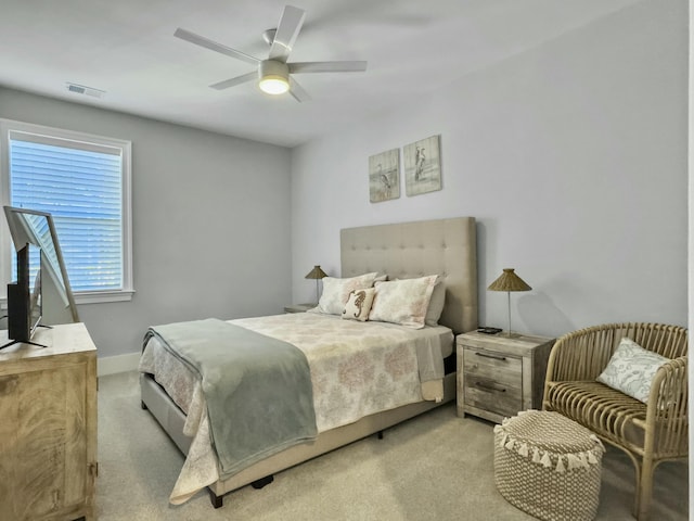 bedroom featuring light colored carpet and ceiling fan