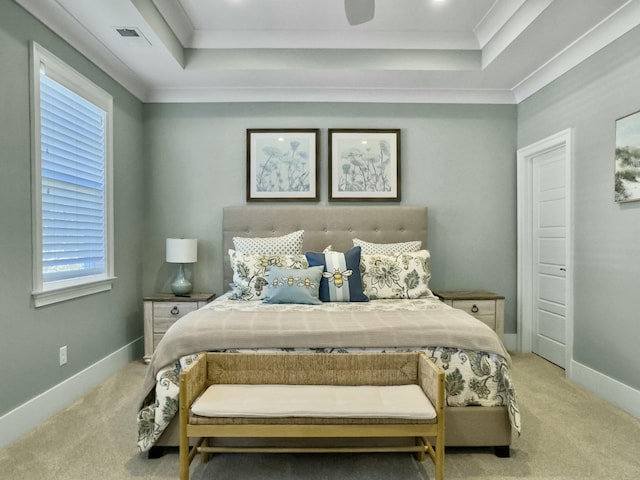 carpeted bedroom featuring ceiling fan, a raised ceiling, and ornamental molding