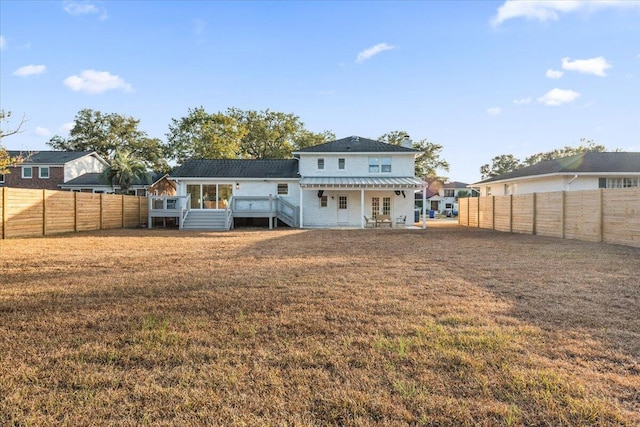 1894 Capri Dr, Charleston, SC 29407 - back of house with a wooden deck, a fenced backyard, and a metal roof