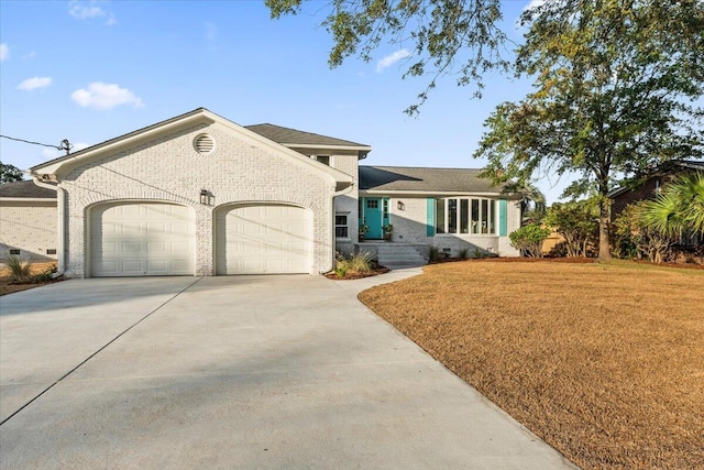 view of front of house with a front lawn and a garage