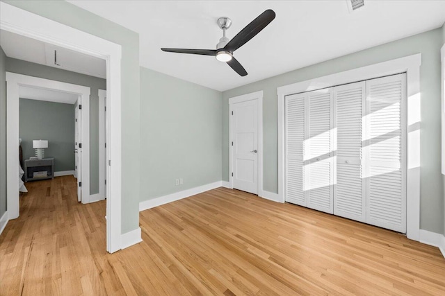 unfurnished bedroom with a closet, light hardwood / wood-style floors, and ceiling fan