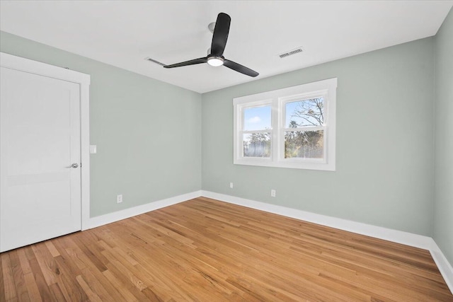 empty room with light hardwood / wood-style flooring and ceiling fan