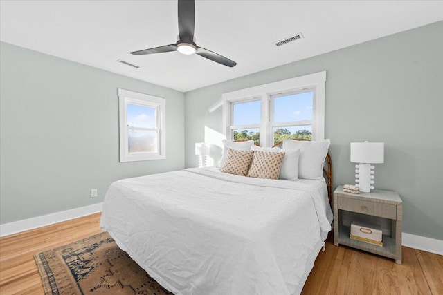 bedroom with ceiling fan and hardwood / wood-style floors