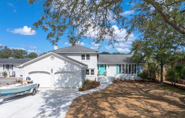 1894 Capri Dr, Charleston, SC 29407 - tri-level home featuring an attached garage, brick siding, and concrete driveway