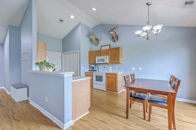 kitchen with visible vents, white appliances, an inviting chandelier, and light countertops