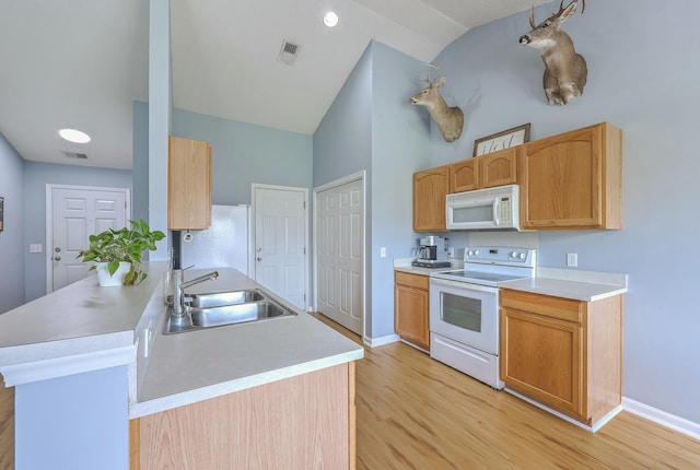 kitchen featuring a sink, visible vents, white appliances, and light countertops