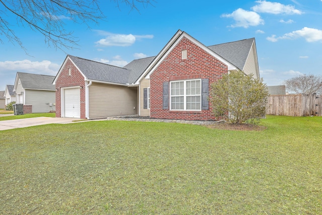 view of front of house with fence, driveway, a front lawn, a garage, and brick siding