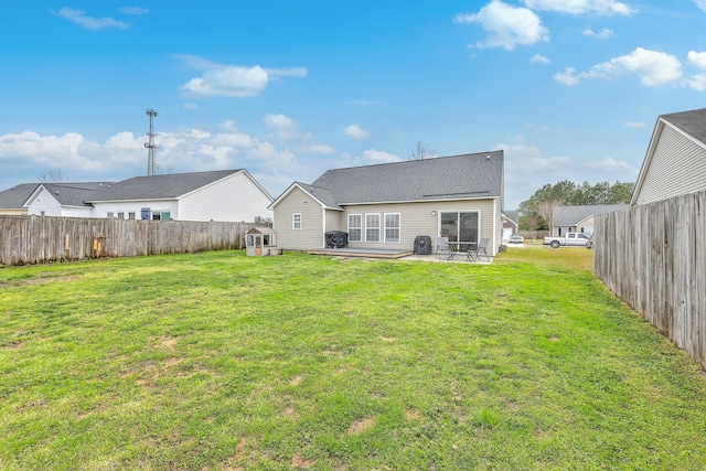 back of house with a yard, a patio, and fence