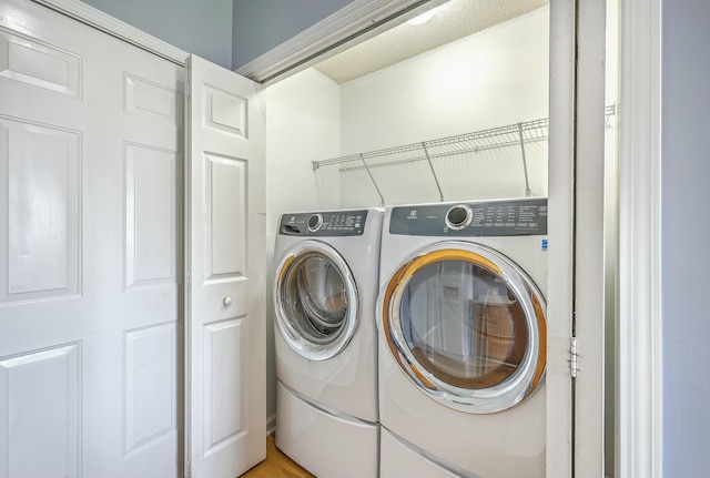 washroom with laundry area and washing machine and dryer