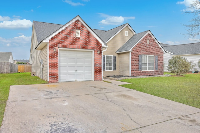 view of front of home featuring a front lawn, concrete driveway, fence, and brick siding