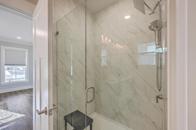 bathroom with an enclosed shower and wood-type flooring