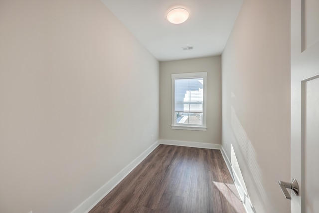 empty room with dark wood-type flooring