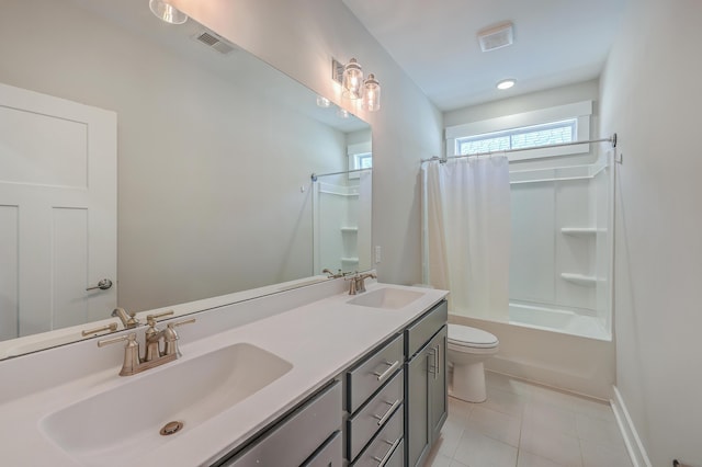 full bathroom featuring toilet, vanity, tile patterned flooring, and shower / tub combo with curtain