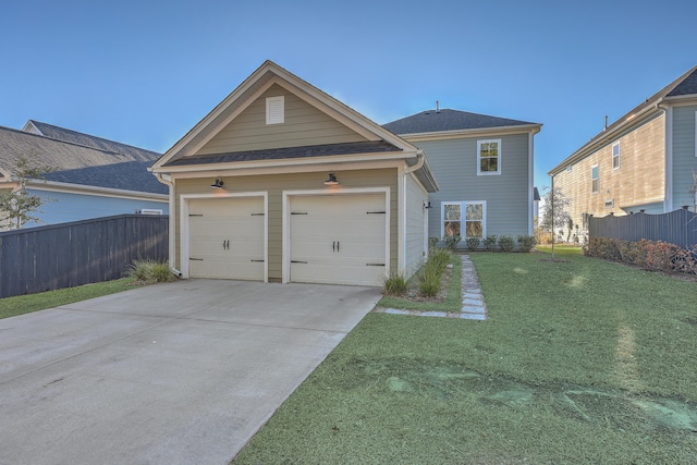 view of front of property with a garage and a front lawn