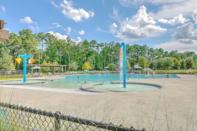 view of swimming pool featuring pool water feature and a patio