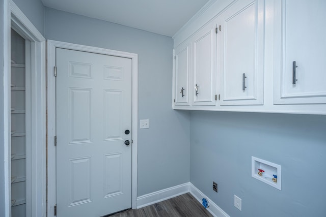washroom with cabinet space, hookup for a washing machine, electric dryer hookup, baseboards, and dark wood finished floors